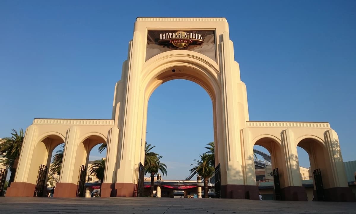 Universal Studios Japan main entrance archway in Osaka — the gate guests pass through to reach the Stage 18 Frieren Story Walk attraction