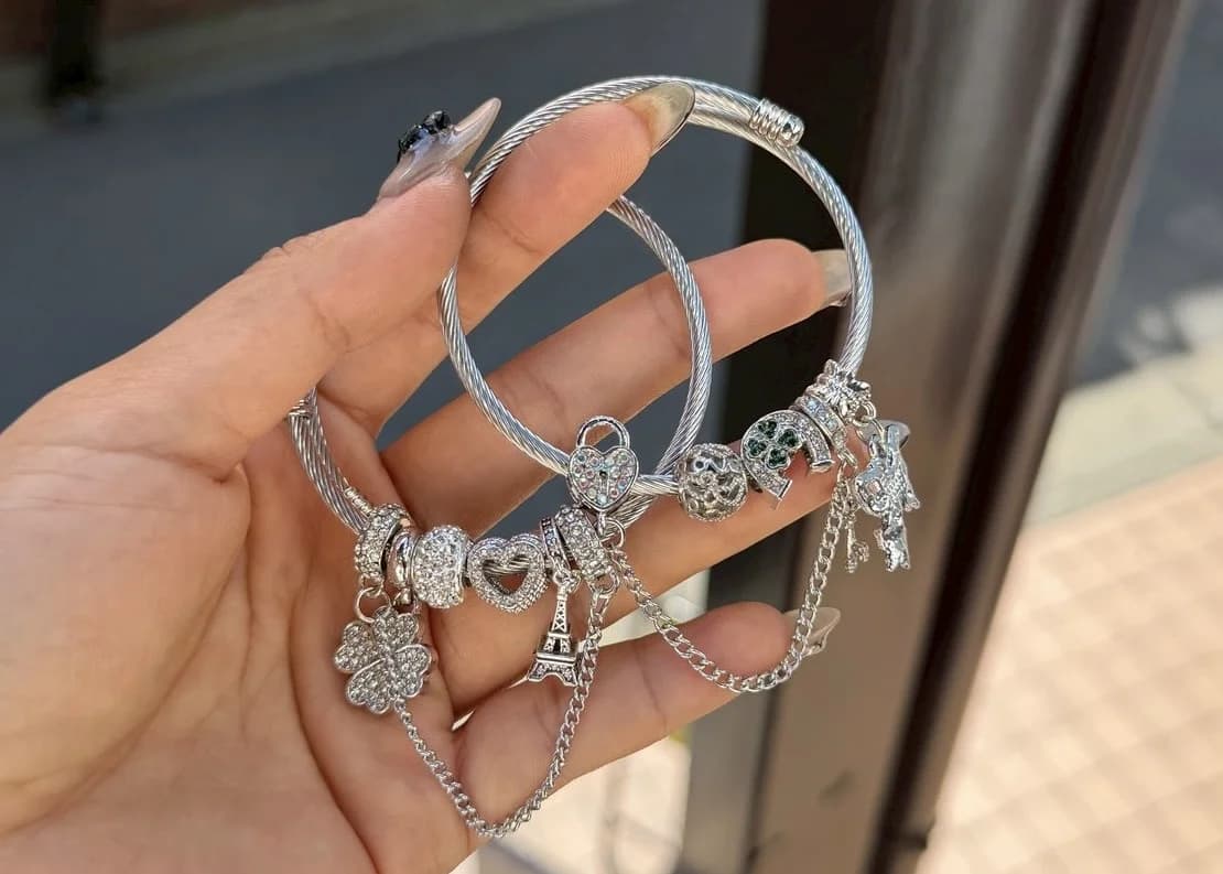 Handmade snake bracelets held up to show detail