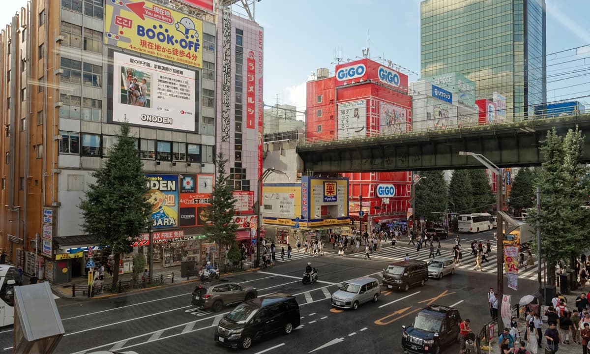 Wide shot of Akihabara Electric Town's main intersection — the Chuo-dori district where the Onoden Building hosts the Cure Maid Café Re:Zero 2026 collab on the 4th floor