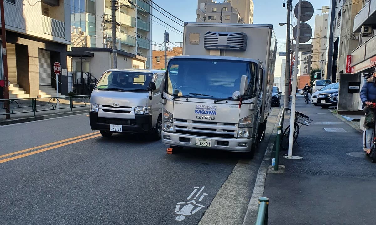 Sagawa Express delivery truck parked on a Japanese street, ready for takkyubin pickup