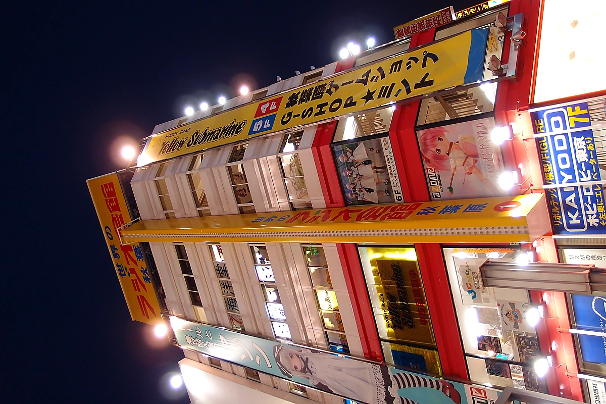 Akihabara storefront at night with bright signage, the visual signature of the Electric Town commercial strip
