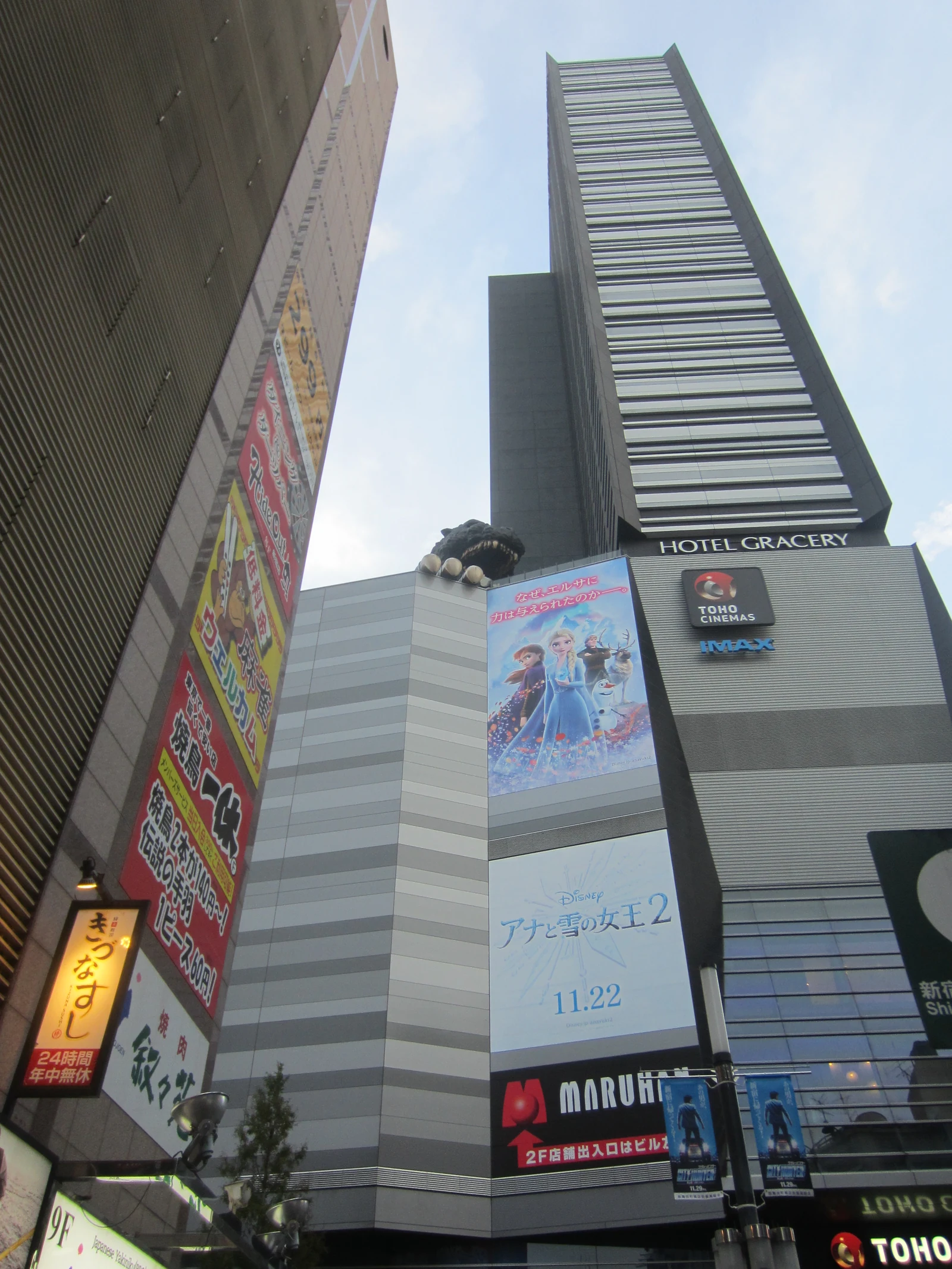 Hotel Gracery Shinjuku tower with TOHO Cinemas signage and the Shinjuku Kabukicho streetscape, a featured Tokyo anime-themed hotel