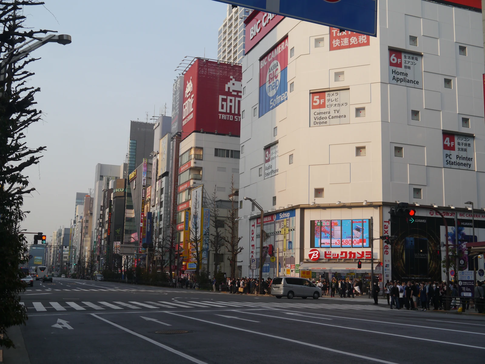 Akihabara Electric Town main street in daytime with anime billboards on the Bic Camera and surrounding buildings