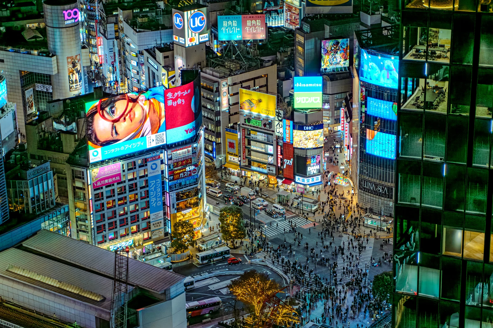 Aerial view of Shibuya Scramble Crossing at night, a location featured in Weathering With You and the Jujutsu Kaisen Shibuya Incident arc