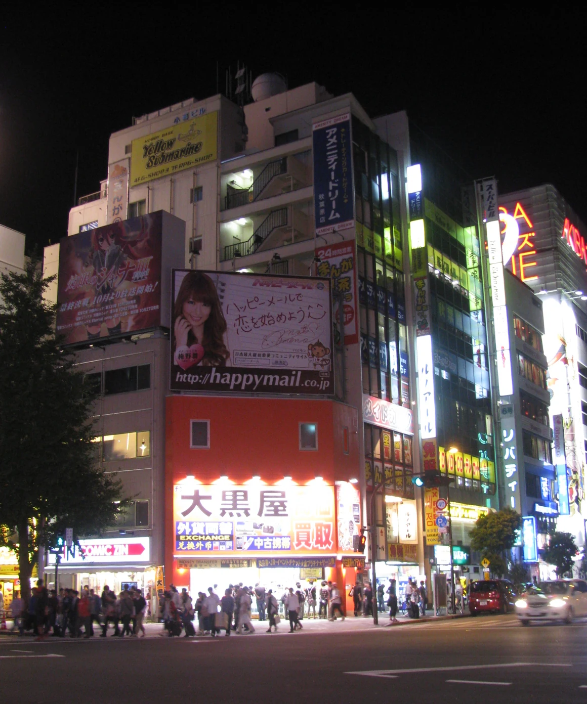 Akihabara Chuo-dori intersection with anime billboards and electronics shop signage that walking tours typically pass through