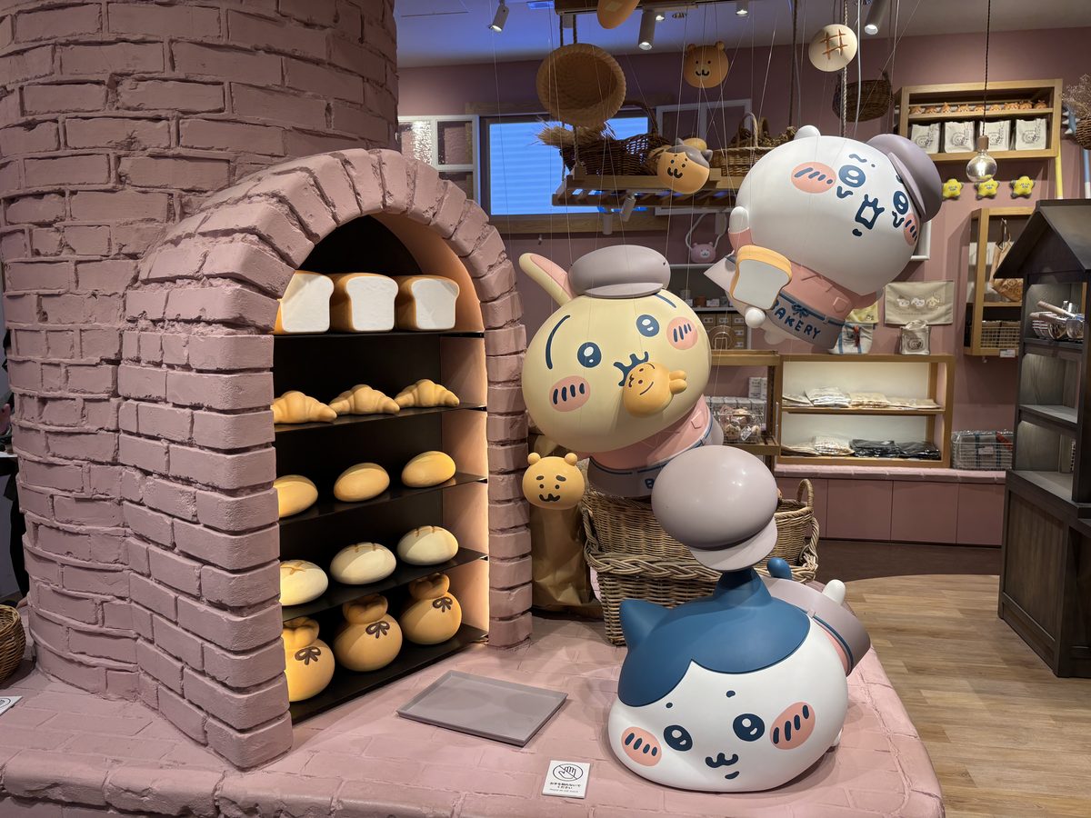 Character-shaped breads displayed inside a brick-oven-style showcase with Chiikawa, Hachiware, and Usagi figure decorations at Chiikawa Bakery Harajuku