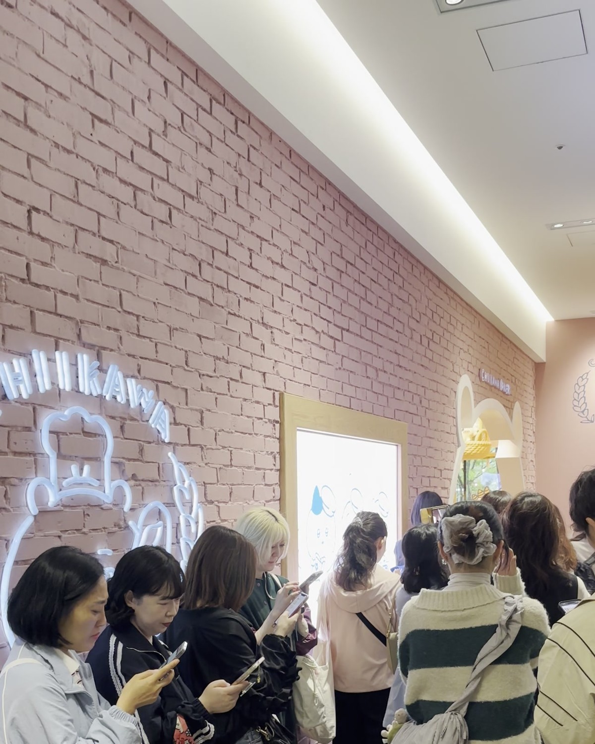 Visitors lining up at the Chiikawa Bakery entrance queue inside Tokyu Plaza Omotesando Harajuku