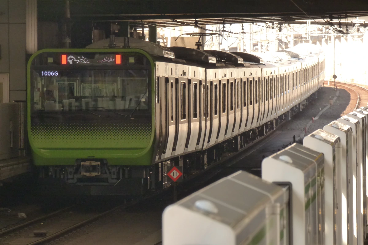 JR East Yamanote Line E235 series train at a Tokyo platform — the green-stripe loop that connects every major Tokyo hub from Shinjuku to Tokyo Station