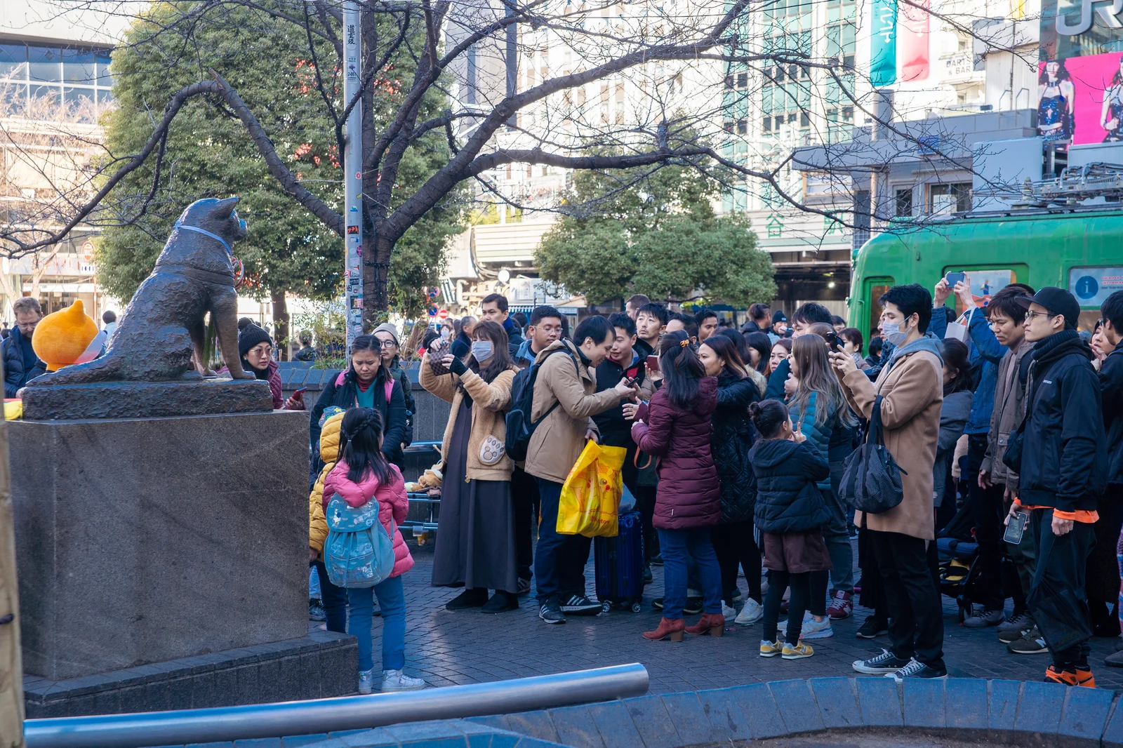 Hachiko bronze statue in Hachiko Square, Shibuya, the southeast-corner landmark of the plaza where the JJK barrier activation scene begins