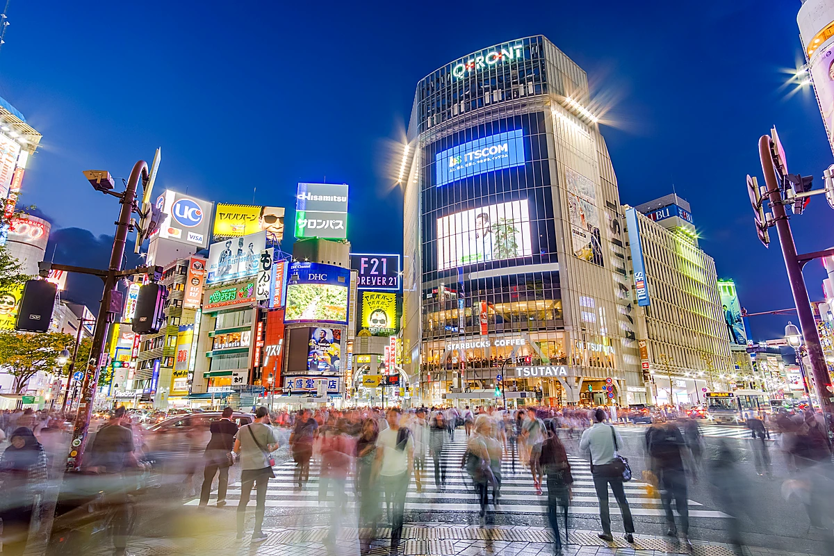 Shibuya Scramble Crossing at dusk — the real-world stage for the JJK Shibuya Incident arc battle scenes