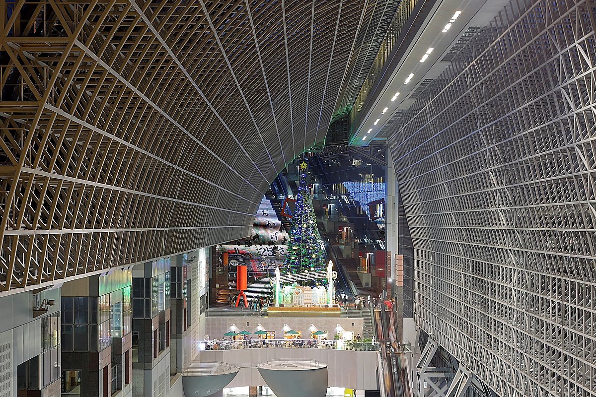 Kyoto Station modern glass-and-steel concourse, the transit hub for most Kyoto anime-pilgrimage day trips