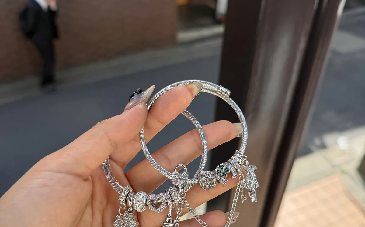 Handmade snake bracelets held up to show detail