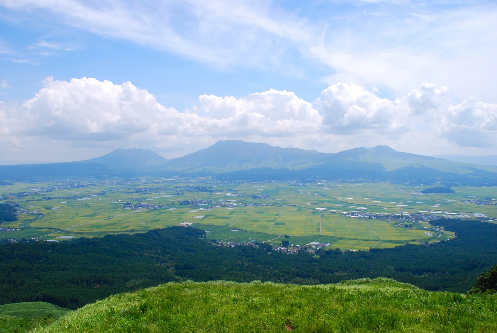 Mount Aso and its sweeping caldera in Kumamoto Prefecture, the volcanic landscape that frames the Usopp, Franky, and Robin statues on the One Piece statue tour