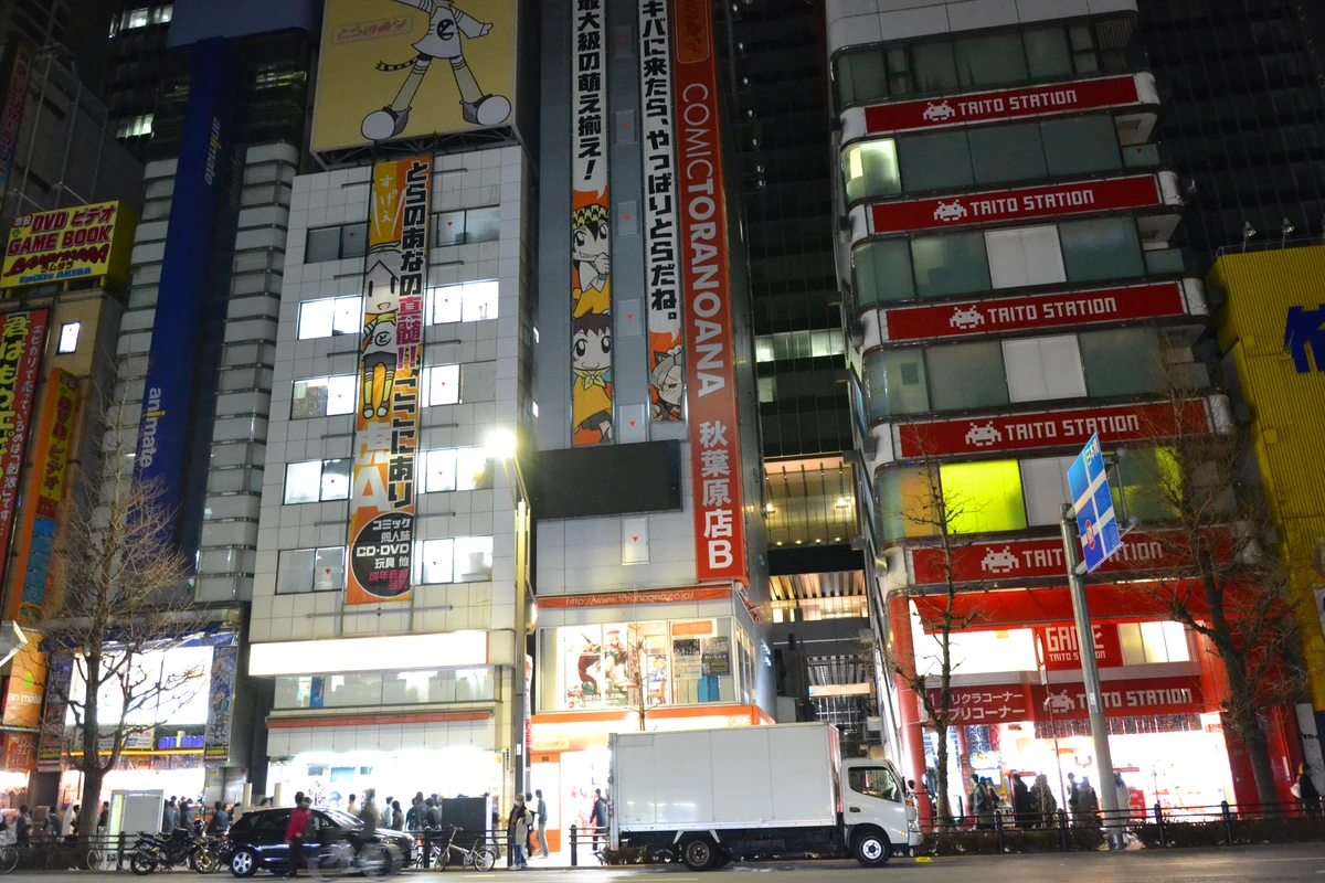 Animate, Lammtarra and Comic Toranoana storefronts on Akihabara Chuo-dori at night, the otaku district that surrounds Cure Maid Café and the Re:Zero collab
