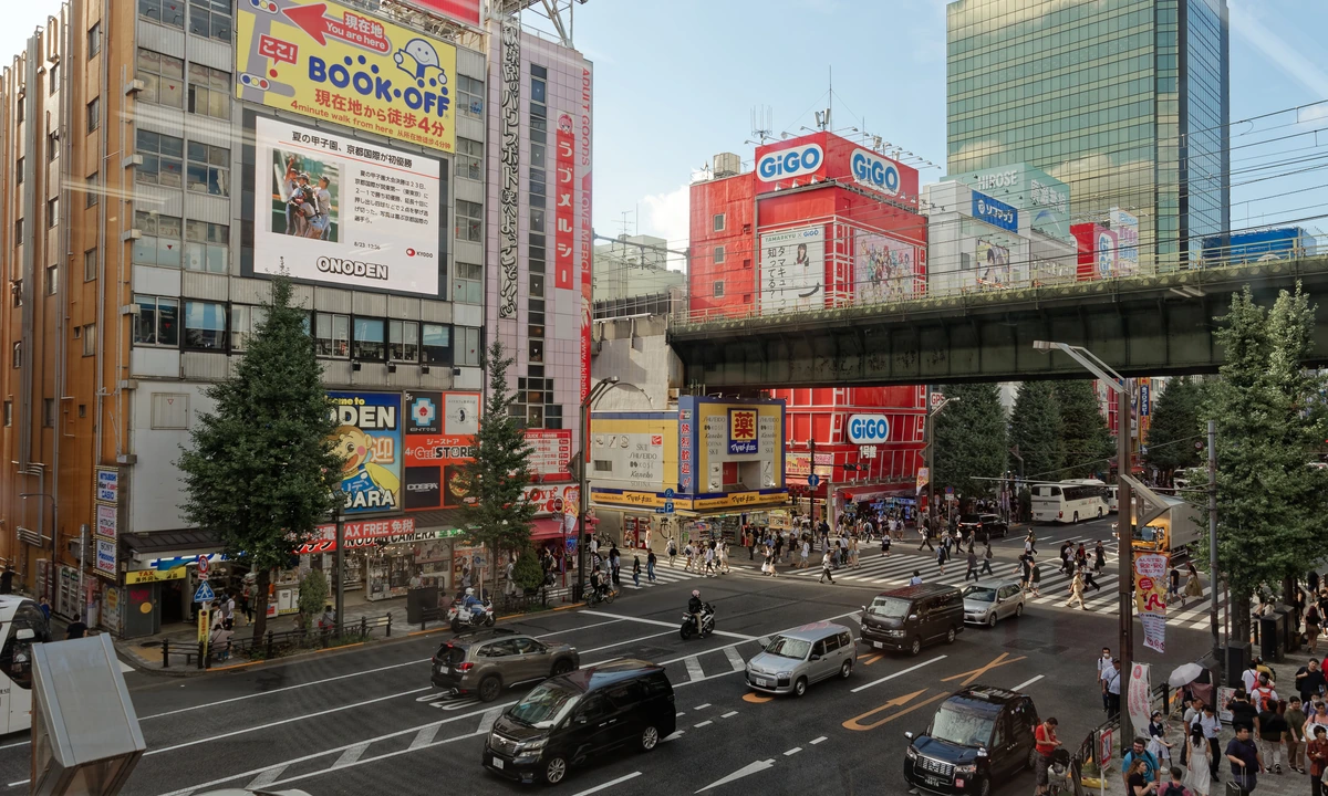 Wide shot of Akihabara Electric Town's main intersection — the Chuo-dori district where the Onoden Building hosts the Cure Maid Café Re:Zero 2026 collab on the 4th floor