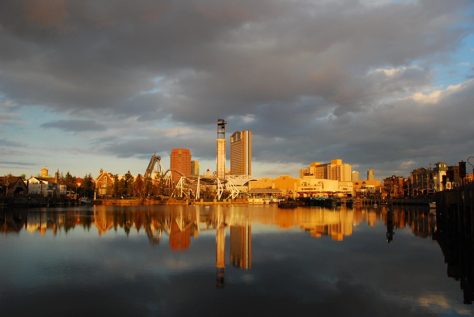 Universal Studios Japan park skyline at sunset showing themed buildings and rides